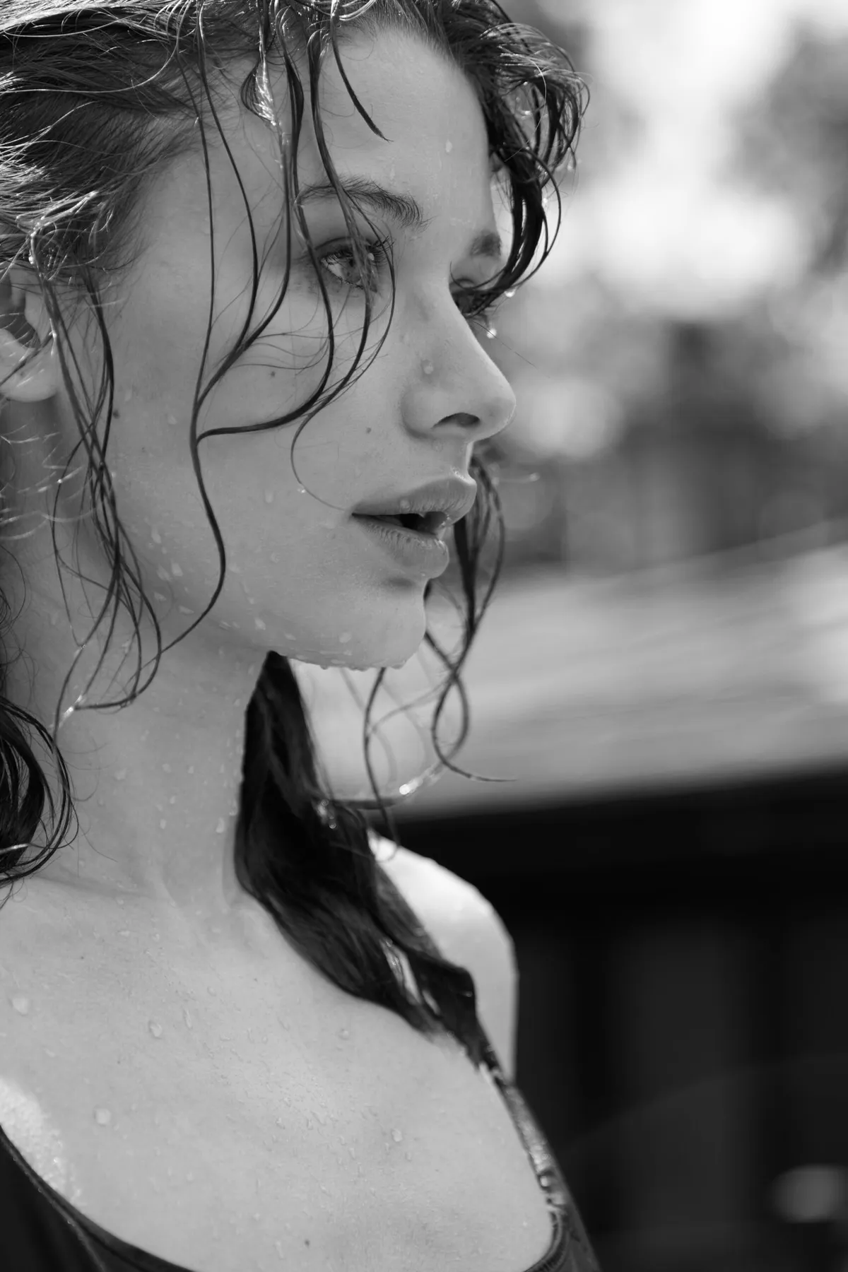 Close black and white profile of a model with wet hair, water on her skin